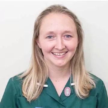 Smiling nurse in green uniform