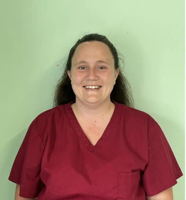 Smiling woman in scrubs