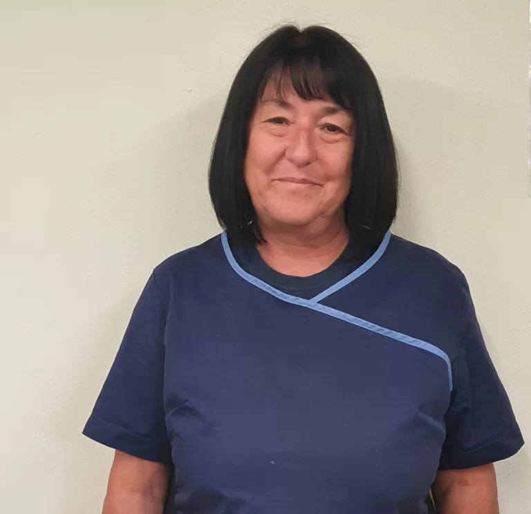 Smiling woman in blue uniform