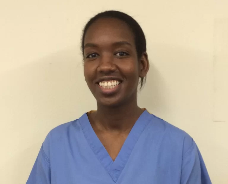 Smiling person in scrubs
